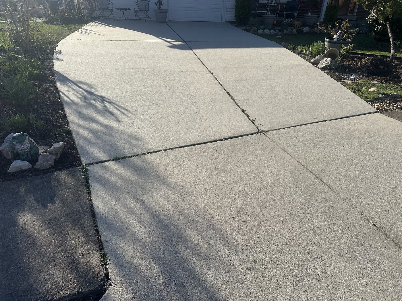 Bright, clean concrete driveway after pressure washing by AHL Wash in Springfield VA
