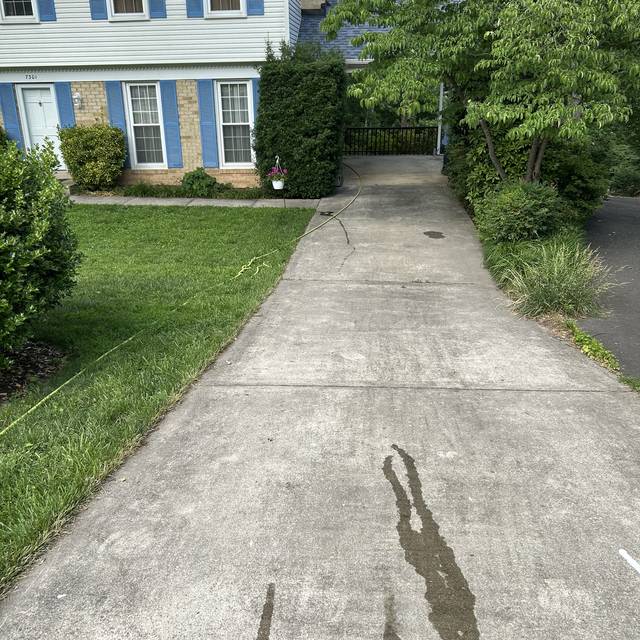 Stained front walkway and driveway before pressure washing in Springfield VA 22153
