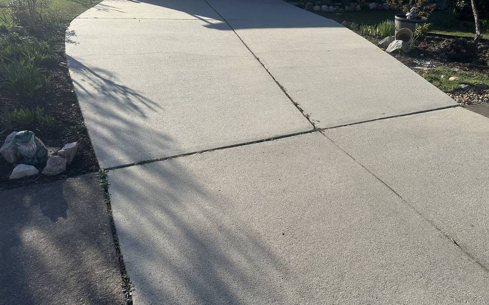 Bright, clean concrete driveway after pressure washing by AHL Wash in Springfield VA
