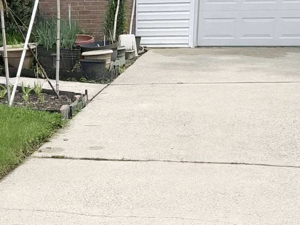 After: the same driveway, bright and evenly clean after AHL Wash